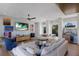 Cozy living area featuring hardwood floors, comfortable seating, and a stylish bar area with a built-in beverage cooler at 581 Kingfisher Ln, Longboat Key, FL 34228