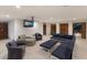 Spacious living area with comfortable seating, TV, and access to outdoor area at 581 Kingfisher Ln, Longboat Key, FL 34228
