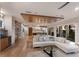 Open-concept living area with hardwood floors, a large sectional sofa, and views of the modern kitchen at 581 Kingfisher Ln, Longboat Key, FL 34228