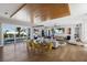 Open-concept living area with floor-to-ceiling windows, modern furnishings, and an elegant dining table at 581 Kingfisher Ln, Longboat Key, FL 34228