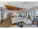 Open-concept living space with a decorative ceiling feature, natural light, and hardwood floors at 581 Kingfisher Ln, Longboat Key, FL 34228