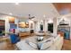 Spacious living room with a tray ceiling, hardwood flooring, comfortable seating, and picturesque views at 581 Kingfisher Ln, Longboat Key, FL 34228