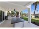 Covered outdoor kitchen area with a large island and stainless steel appliances at 581 Kingfisher Ln, Longboat Key, FL 34228