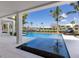 Inviting pool area with sun loungers surrounded by lush landscaping at 581 Kingfisher Ln, Longboat Key, FL 34228