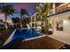 Beautiful backyard with a large pool, wooden deck, and manicured landscaping at 581 Kingfisher Ln, Longboat Key, FL 34228