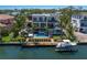 Modern waterfront home featuring a private pool, dock, and lush landscaping for an ultimate outdoor living experience at 581 Kingfisher Ln, Longboat Key, FL 34228