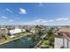 Beautiful waterfront view overlooking a canal with luxury homes and boats in the background under a blue sky at 581 Kingfisher Ln, Longboat Key, FL 34228