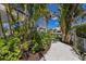Lush landscaping around the property with a winding pathway at 581 Kingfisher Ln, Longboat Key, FL 34228