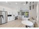 Modern kitchen space featuring stainless steel appliances and sleek white cabinetry at 5861 Bungalow Grove Ct, Palmetto, FL 34221