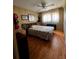 Bright bedroom with a large window, complemented by wood floors, and closet at 606 Cyprus Ct, Bradenton, FL 34207