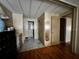 Hallway leading to a bathroom and bedroom with laminate wood floors and closet at 606 Cyprus Ct, Bradenton, FL 34207