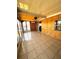 Spacious tiled lanai with wooden wall, ceiling fan, and sliding doors for comfortable outdoor living at 606 Cyprus Ct, Bradenton, FL 34207