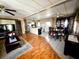 Open-concept living and dining area with wood laminate flooring and abundant natural light at 606 Cyprus Ct, Bradenton, FL 34207