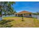 Large backyard with a well-maintained lawn, privacy fence, and a small tree in the center at 6106 34Th E Ct, Ellenton, FL 34222