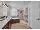 Luxurious bathroom features a dual vanity, soaking tub, glass shower, and modern fixtures and finishes at 6106 34Th E Ct, Ellenton, FL 34222