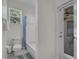 Bathroom features white toilet, tub with shower, and an exterior door with privacy window at 6106 34Th E Ct, Ellenton, FL 34222