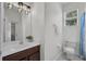 Bright bathroom with wood vanity, a white sink, and a separate toilet area at 6106 34Th E Ct, Ellenton, FL 34222
