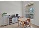 Bright dining space featuring a quaint table set, a modern cabinet, and a sunlit window at 6106 34Th E Ct, Ellenton, FL 34222