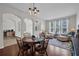 Bright and airy dining area open to the living room, featuring hardwood floors and stylish chandelier at 6106 34Th E Ct, Ellenton, FL 34222
