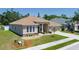 Exterior shot featuring a well-maintained lawn, a front garden, and a light brown roof at 6106 34Th E Ct, Ellenton, FL 34222