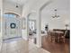 Bright, open foyer with tiled floor, leading to dining and living areas through elegant arched doorways at 6106 34Th E Ct, Ellenton, FL 34222