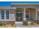 Elegant front entrance with arched columns and a beautifully decorated glass door at 6106 34Th E Ct, Ellenton, FL 34222