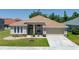 Charming single-story home with a well-manicured lawn and two-car garage, showcasing its inviting curb appeal at 6106 34Th E Ct, Ellenton, FL 34222