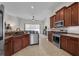 Open kitchen featuring wood cabinets, stainless steel appliances, and tile flooring overlooking the living room at 6106 34Th E Ct, Ellenton, FL 34222
