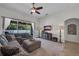 Inviting living room features a large sectional sofa, TV, and natural light from sliding glass doors at 6106 34Th E Ct, Ellenton, FL 34222
