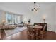 Bright living room with hardwood floors, neutral decor, and ample natural light from large windows at 6106 34Th E Ct, Ellenton, FL 34222
