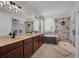 Luxurious bathroom with double vanity, soaking tub, and a walk-in shower with tiled walls at 6106 34Th E Ct, Ellenton, FL 34222