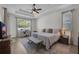 Relaxing main bedroom featuring a ceiling fan, natural light, and an adjacent study area at 6106 34Th E Ct, Ellenton, FL 34222