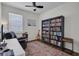 Bright office space features a ceiling fan, decorative rug, guitar, and large bookcase at 6106 34Th E Ct, Ellenton, FL 34222