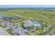 Aerial view of community pool, tennis courts, and bocce ball near walking trails at 6120 Plateau Ct, Bradenton, FL 34203