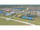 Aerial view of planned community featuring tennis courts, pool, and clubhouse at 6120 Plateau Ct, Bradenton, FL 34203