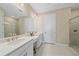 A bathroom showcases a dual-sink vanity, with a framed mirror and tile flooring at 6120 Plateau Ct, Bradenton, FL 34203