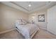 A bedroom features a tray ceiling, neutral walls and carpeted floor, with an ensuite at 6120 Plateau Ct, Bradenton, FL 34203