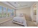 A bedroom with tray ceiling, carpeted floors and a window with natural light at 6120 Plateau Ct, Bradenton, FL 34203