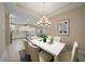 Dining room with a large white table, seating for six, and an open-concept kitchen at 6120 Plateau Ct, Bradenton, FL 34203