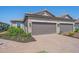 Attractive home featuring a three-car garage with a brick-paved driveway and neatly landscaped yard at 6120 Plateau Ct, Bradenton, FL 34203