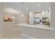 A spacious kitchen with a large island, modern pendant lights, and stainless steel appliances flows into dining area at 6120 Plateau Ct, Bradenton, FL 34203
