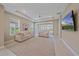 Bright, spacious living room with recessed lighting, modern decor, and expansive sliding glass doors at 6120 Plateau Ct, Bradenton, FL 34203