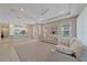 Open-concept living room featuring neutral decor, ceiling fan, and seamless access to the kitchen at 6120 Plateau Ct, Bradenton, FL 34203