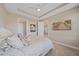 Main bedroom features a tray ceiling, carpet flooring, an ensuite bathroom and a television at 6120 Plateau Ct, Bradenton, FL 34203