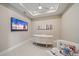 Home office equipped with modern desk, flat-screen TV, and decorative wall art at 6120 Plateau Ct, Bradenton, FL 34203