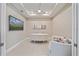 Home office featuring a modern desk, comfortable seating, and a flat-screen television at 6120 Plateau Ct, Bradenton, FL 34203