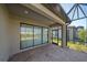 A covered brick patio with a clear view of the adjacent backyard area and home exterior at 6120 Plateau Ct, Bradenton, FL 34203
