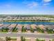 Stunning aerial shot of a well-maintained community showcasing homes and a beautiful lake at 6266 Mesa Gln, Bradenton, FL 34203