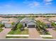 Beautiful aerial view of a home and community near a tranquil lake with lush landscaping at 6266 Mesa Gln, Bradenton, FL 34203