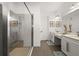 This bathroom offers dual vanities with framed mirrors, a walk-in shower, and modern fixtures at 6266 Mesa Gln, Bradenton, FL 34203